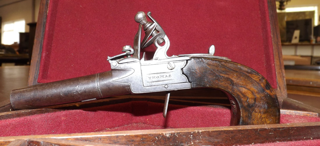 Picture Lot 176, a small boxed flintlock pistol by Thomas.  